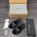 Black sport sandals with wide straps and thick textured sole, pair with adjustable buckles.