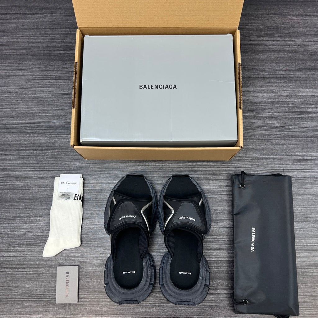 Black sandals with multiple straps and chunky sole, open-toe design shown from above.