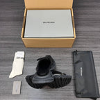 Black sandals with chunky outsole and wide footbed straps, rear view of the pair.