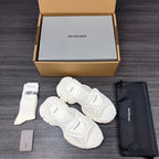 Balenciaga white sporty slide sandals with curved straps, angled view