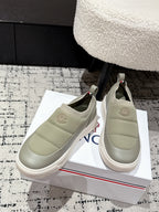 Moncler slip-on shoes in light olive with embroidered logo badge and cushioned sole.