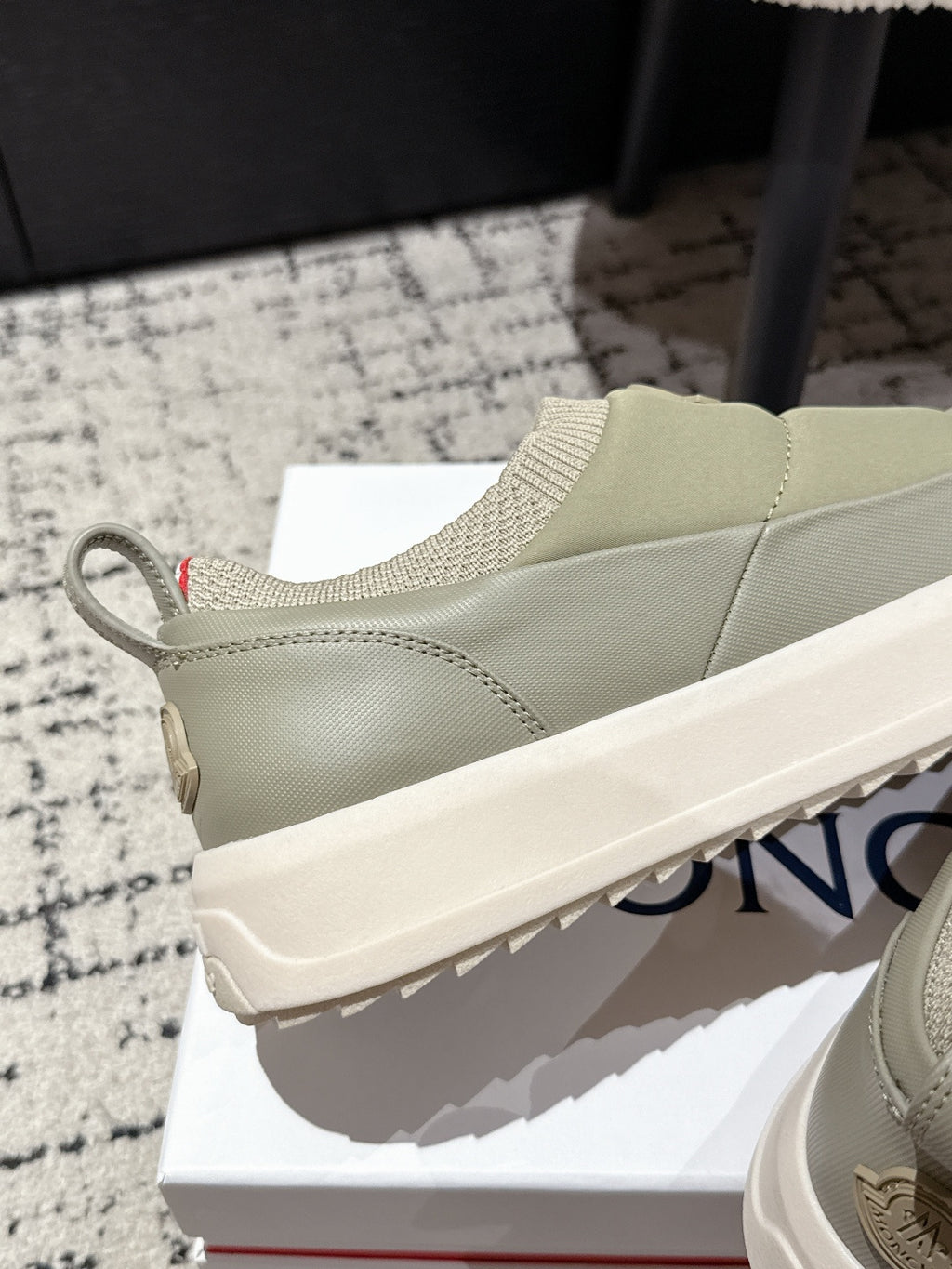 Moncler slip-on shoes in light olive with rear pull tab and chunky textured sole.