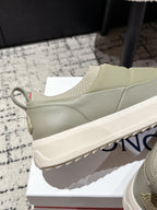 Moncler slip-on shoes in light olive with rear pull tab and chunky textured sole.