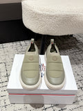 Moncler slip-on shoes in light olive with elastic side panels and round toe.