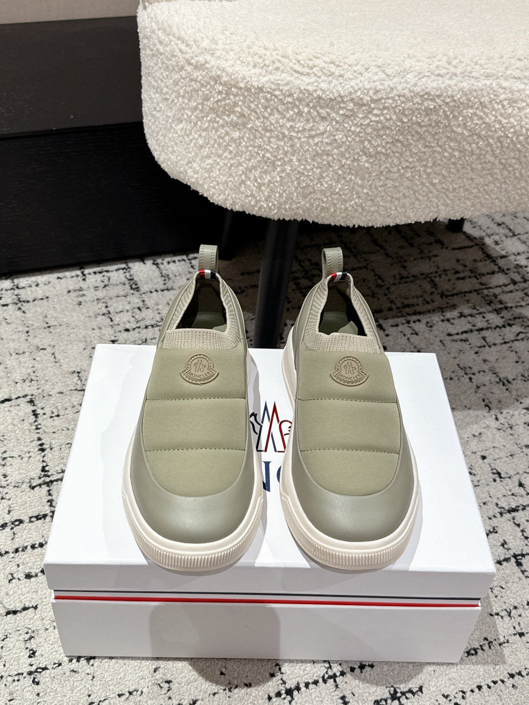 Moncler slip-on shoes in light olive with elastic side panels and round toe.