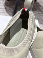 Moncler slip-on shoe interior view in light olive with woven collar edge.