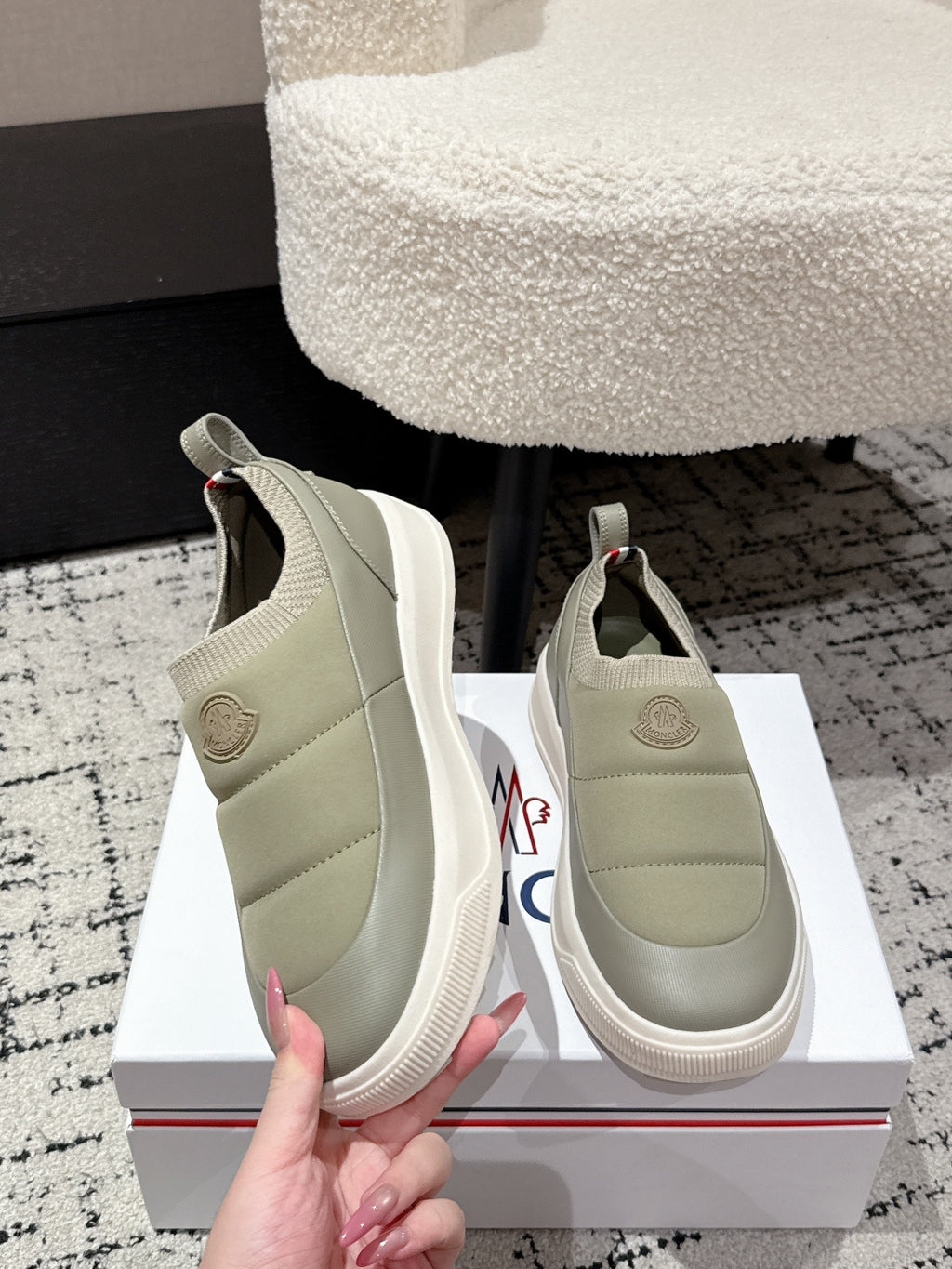 Moncler slip-on shoes in light olive with logo patch at heel and elastic panels.
