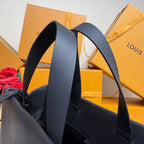 Navy Louis Vuitton tote bag showing textured leather strap and side panel