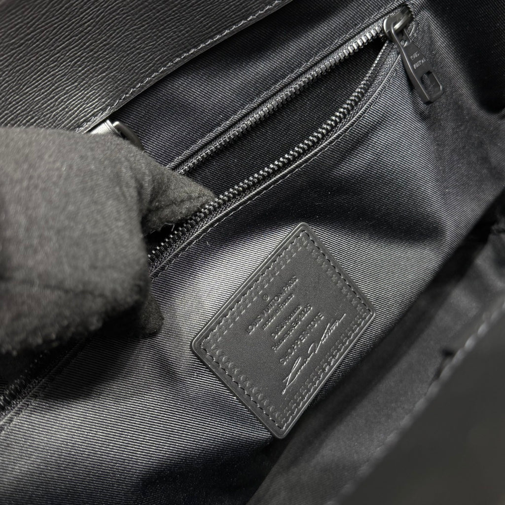 Louis Vuitton leather bag interior with zip pocket and stamped patch