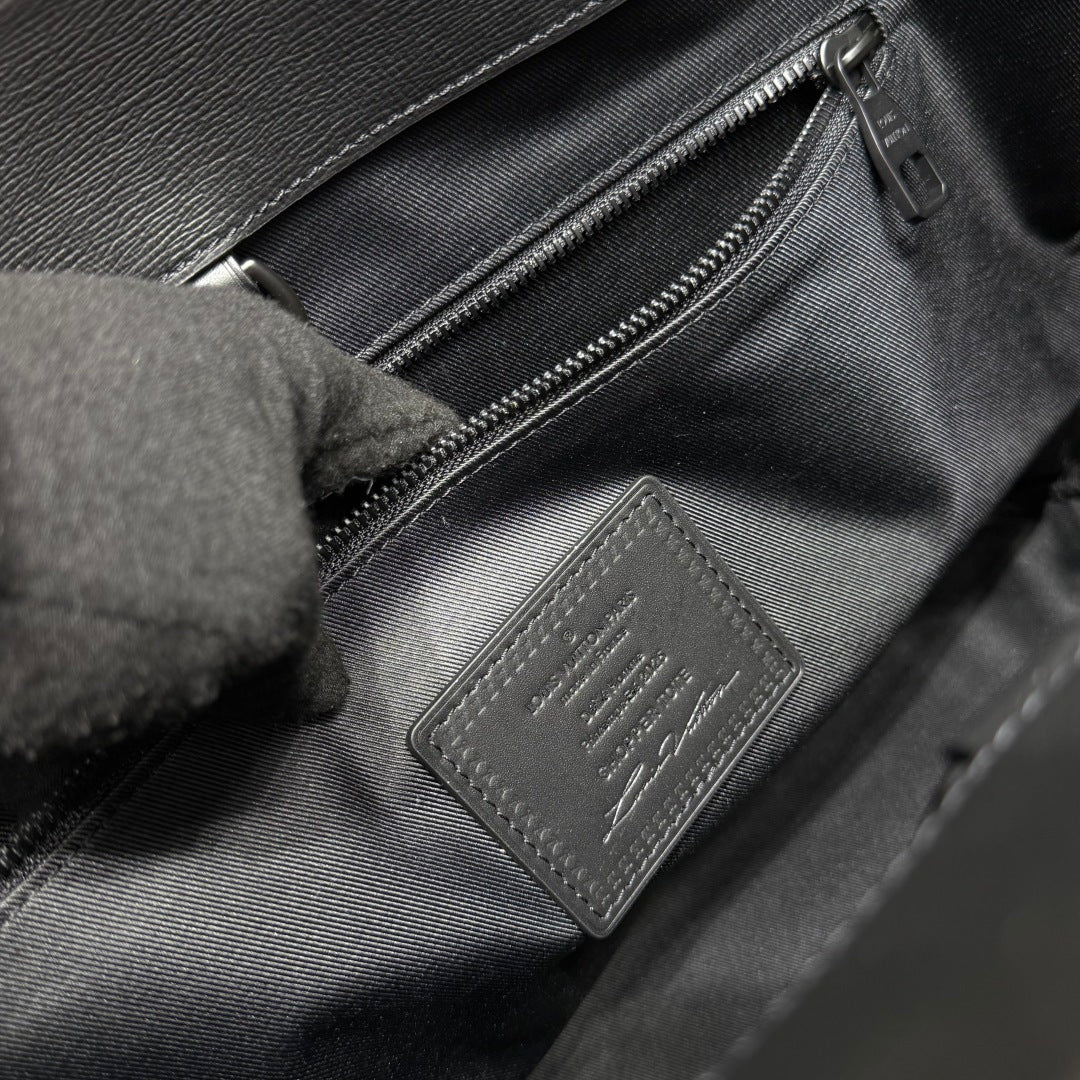 Louis Vuitton bag interior leather tag and zipper close-up in dark gray.