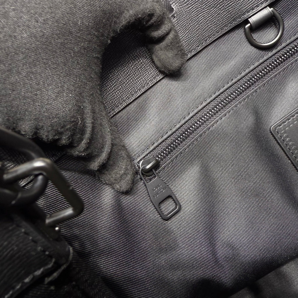 Navy Louis Vuitton bag interior close-up with zipper pull and fabric lining