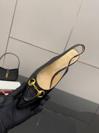 Women's Gucci black loafer with gold horsebit, interior lining visible