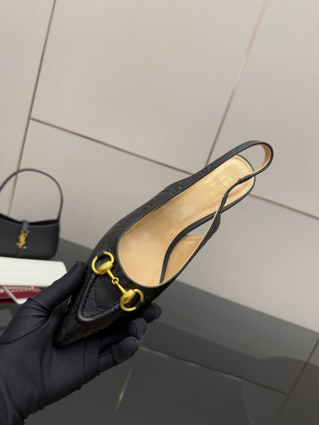 Women's Gucci black loafer with gold horsebit, interior lining visible