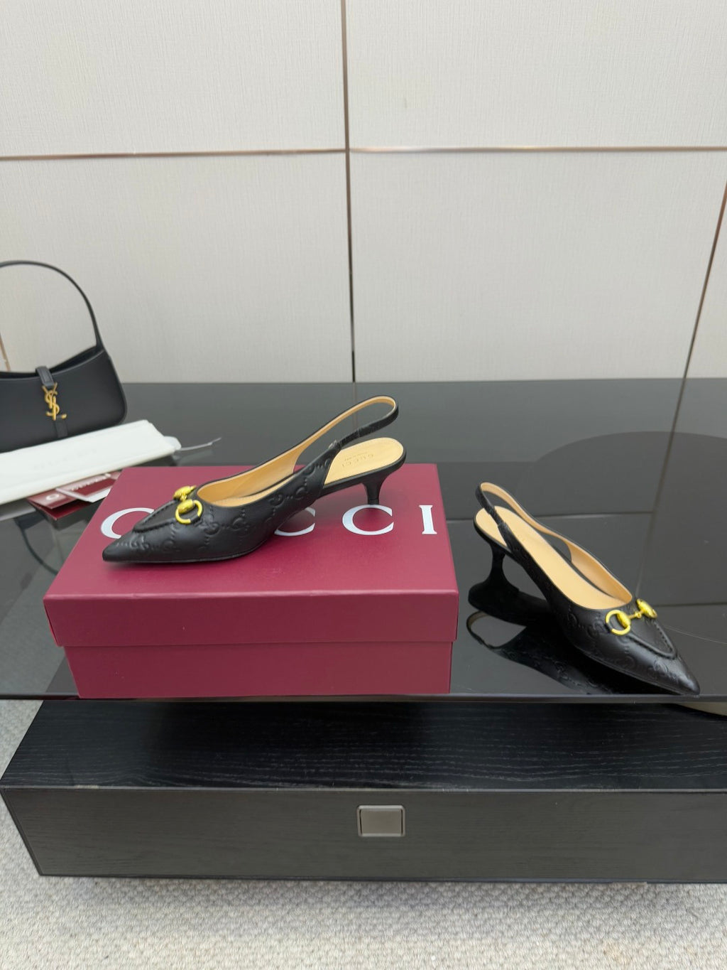 Women's Gucci black slingback loafers with gold horsebit detail, side view