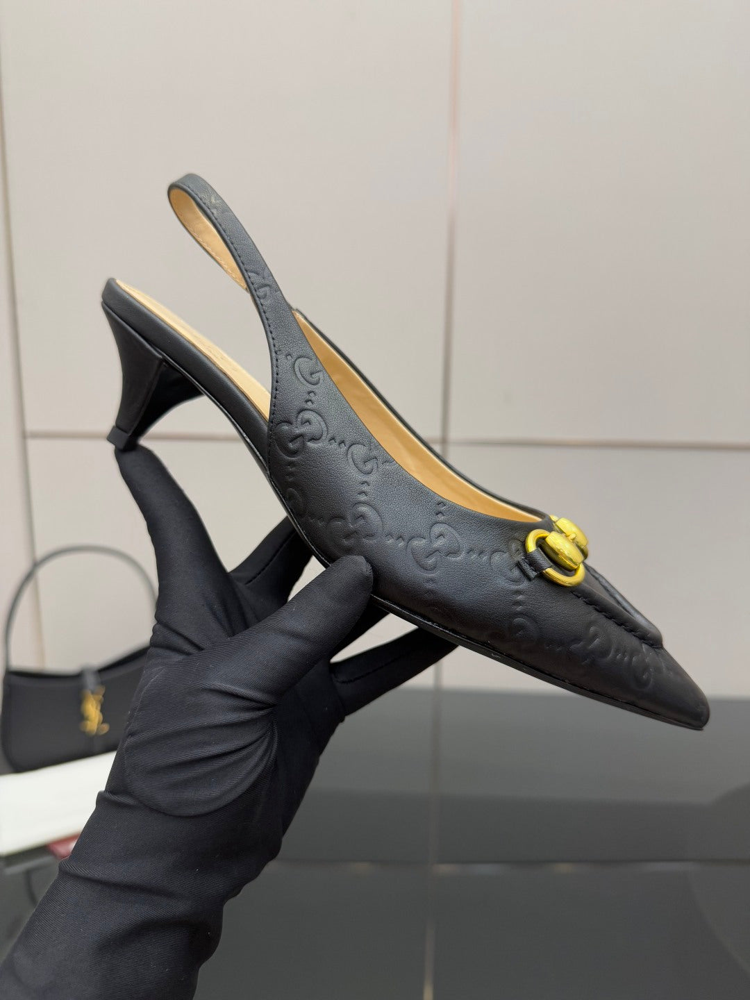 Women's Gucci black pointed-toe loafer with gold horsebit, high heel view