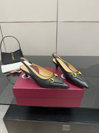 Women's Gucci black loafers with gold horsebit hardware, pointed-toe