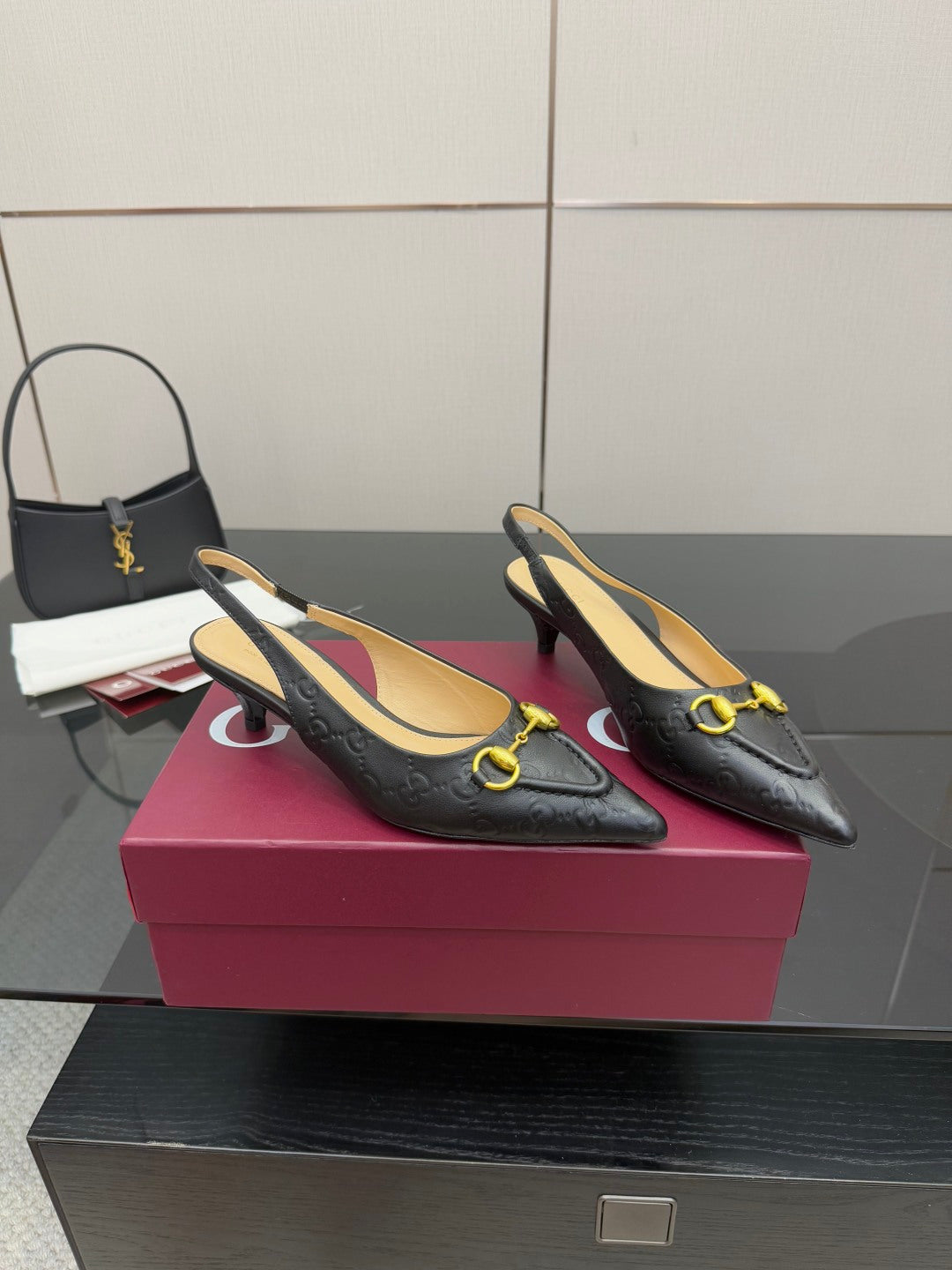 Women's Gucci black loafers with gold horsebit hardware, pointed-toe