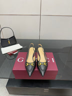 Women's Gucci black loafers with gold horsebit hardware