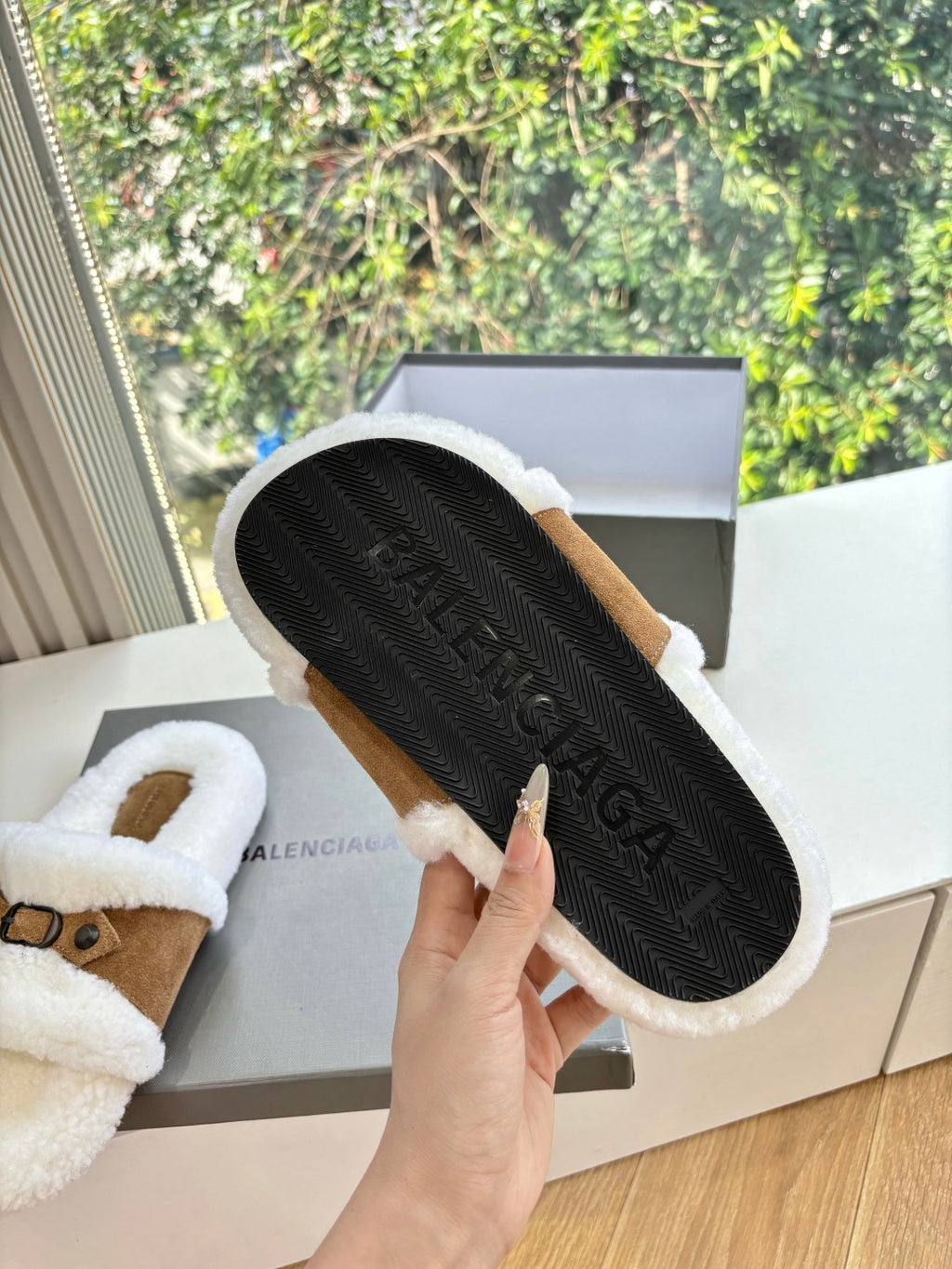 Balenciaga shearling slide sandals, black textured outsole on white fuzzy slide