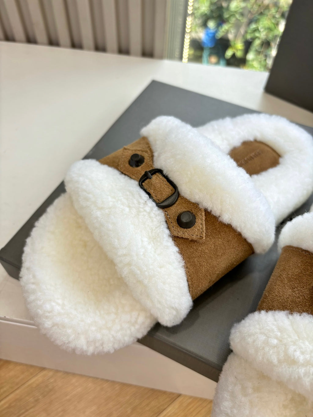Balenciaga shearling slide sandals, brown suede upper with white plush trim; close-up