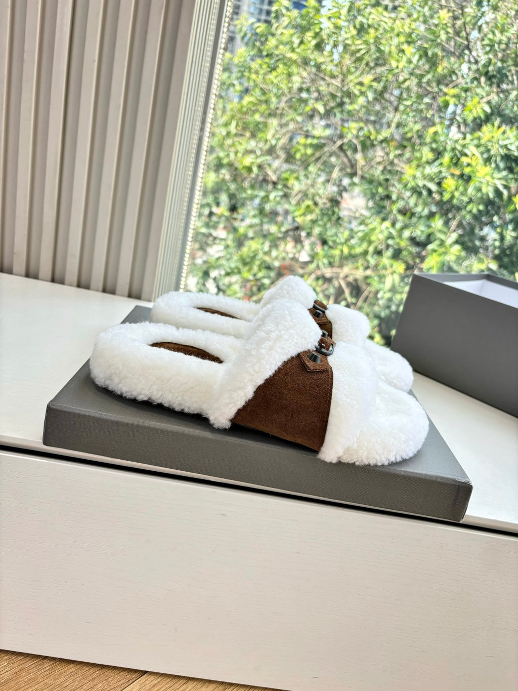 Women's sherpa slip-on sandals with brown suede toe strap and buckle