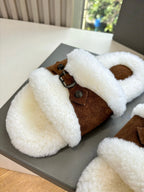 Women's brown-and-white sherpa slides with buckle strap and oval cutout
