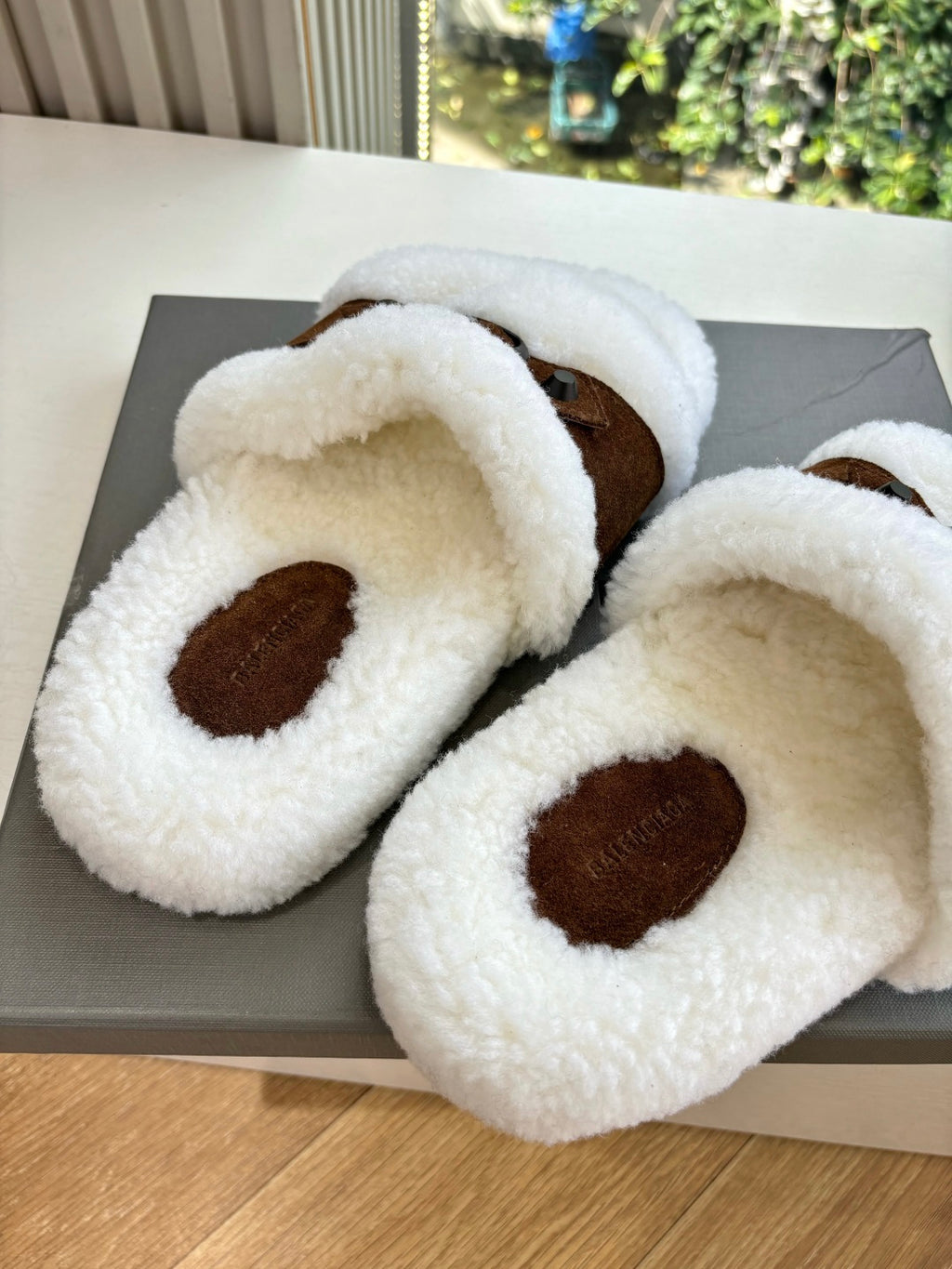 Women's sherpa slide sandals with brown suede oval patch at front