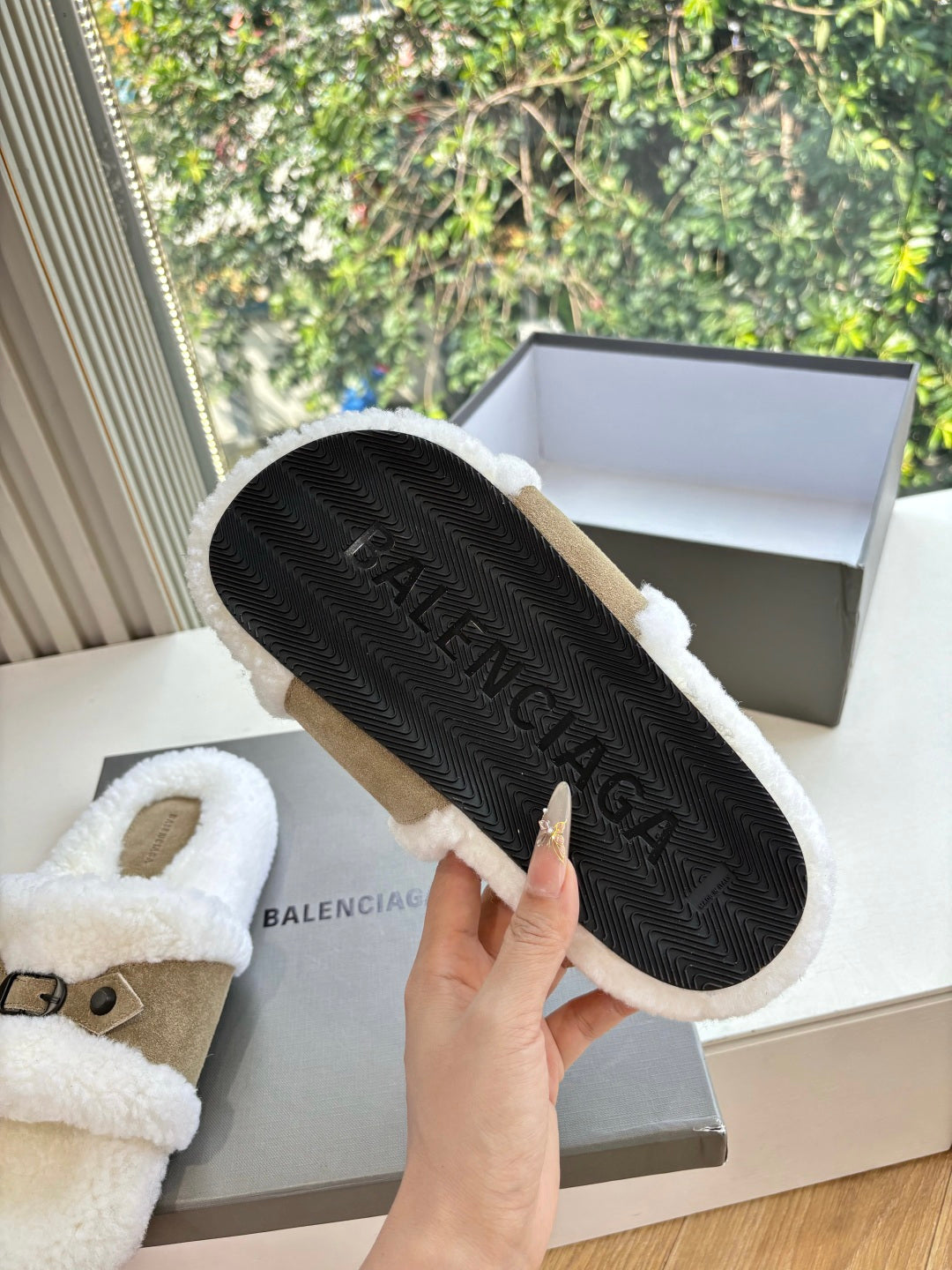Balenciaga women’s sherpa sandals with textured outsole visible, tan suede strap
