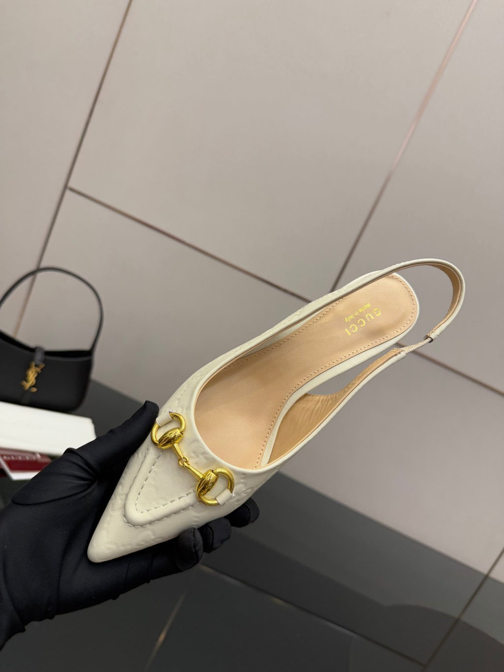 Cream slingback flat pump with gold horsebit and curved strap