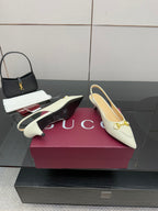 Cream slingback pumps with gold horsebit hardware and low heel