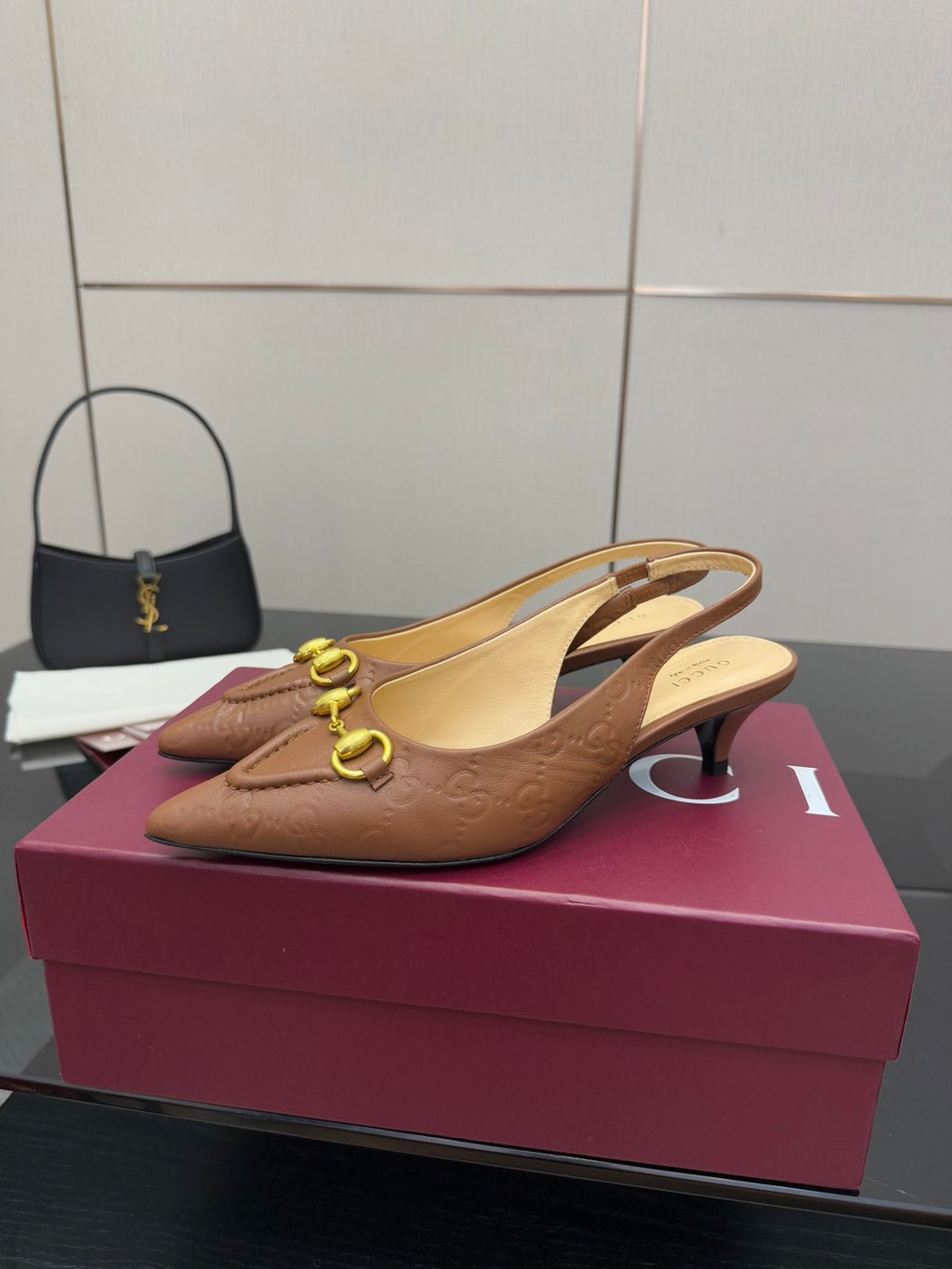 Brown slingback heels with gold-tone hardware and low heel, pointed toe