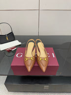 Brown leather slingback heels with gold-tone buckle detail, pointed toe