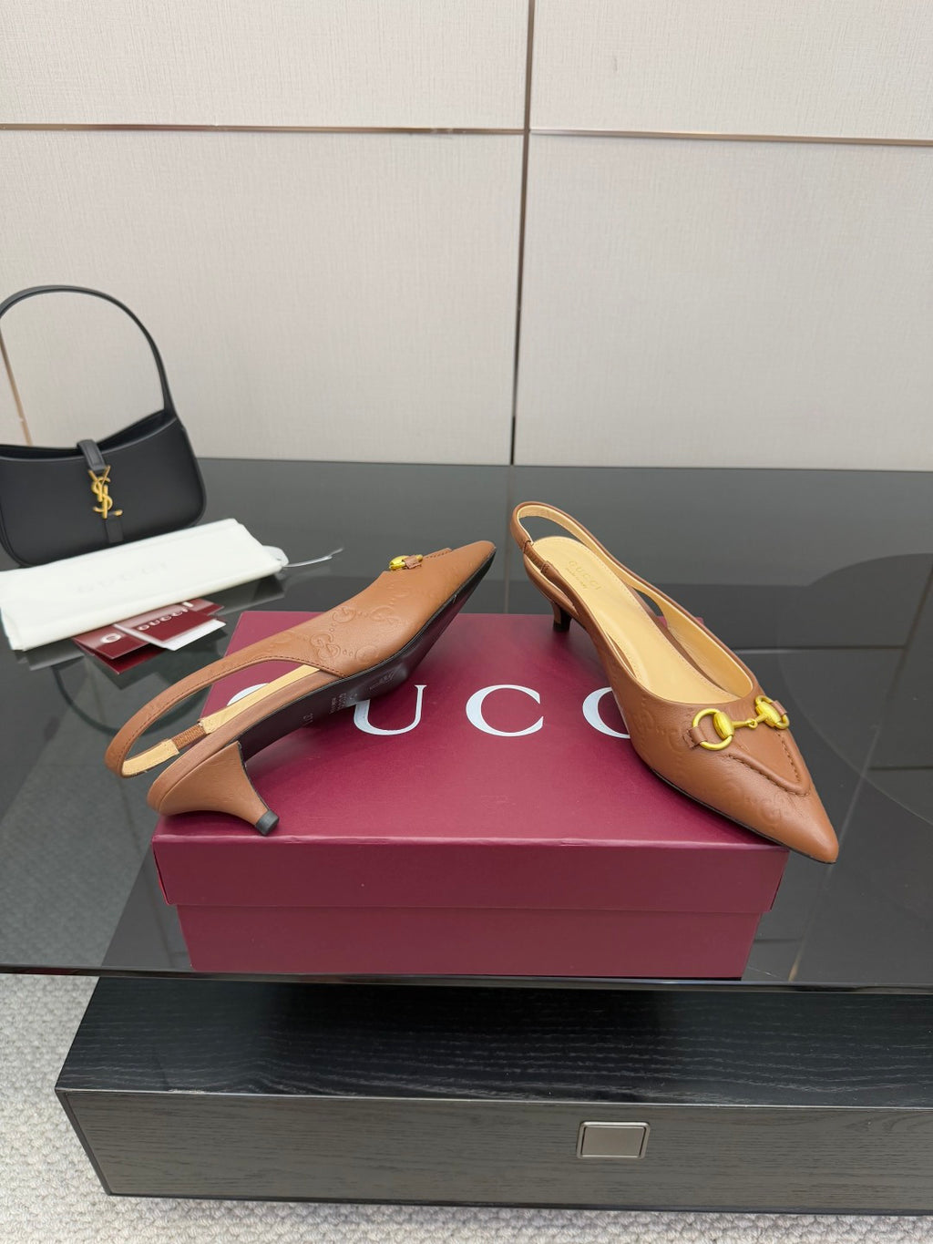 Brown slingback heels with gold-tone hardware and slim heel, pointed toe
