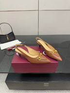 Pair of brown slingback heels with gold ring buckle detail and pointed toe