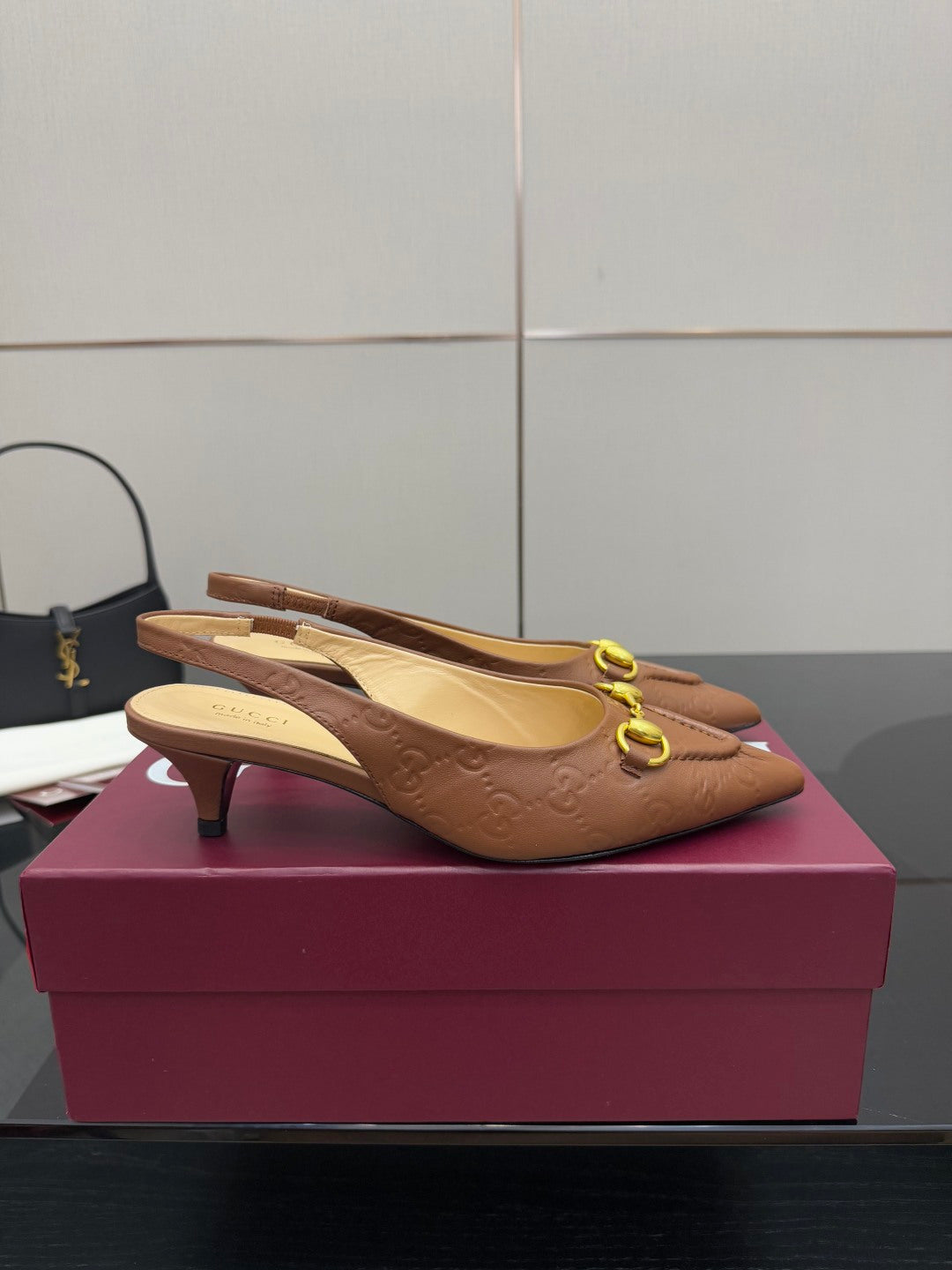 Brown slingback heels with textured finish, gold-tone ring hardware and heel