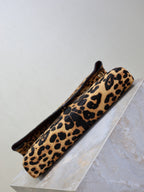 YSL leopard-print shoulder bag lying on display with flap opening