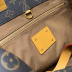 Louis Vuitton monogram bag with tan strap, gold zipper, leather logo patch