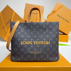 Louis Vuitton monogram tote bag with leather handles, dark canvas, and gold logo on front.