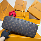 Louis Vuitton monogram shoulder bag in dark canvas, laid sideways with gold-tone accents.