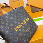 Louis Vuitton monogram tote bag close-up on side panel with gold logo print and patterned canvas.