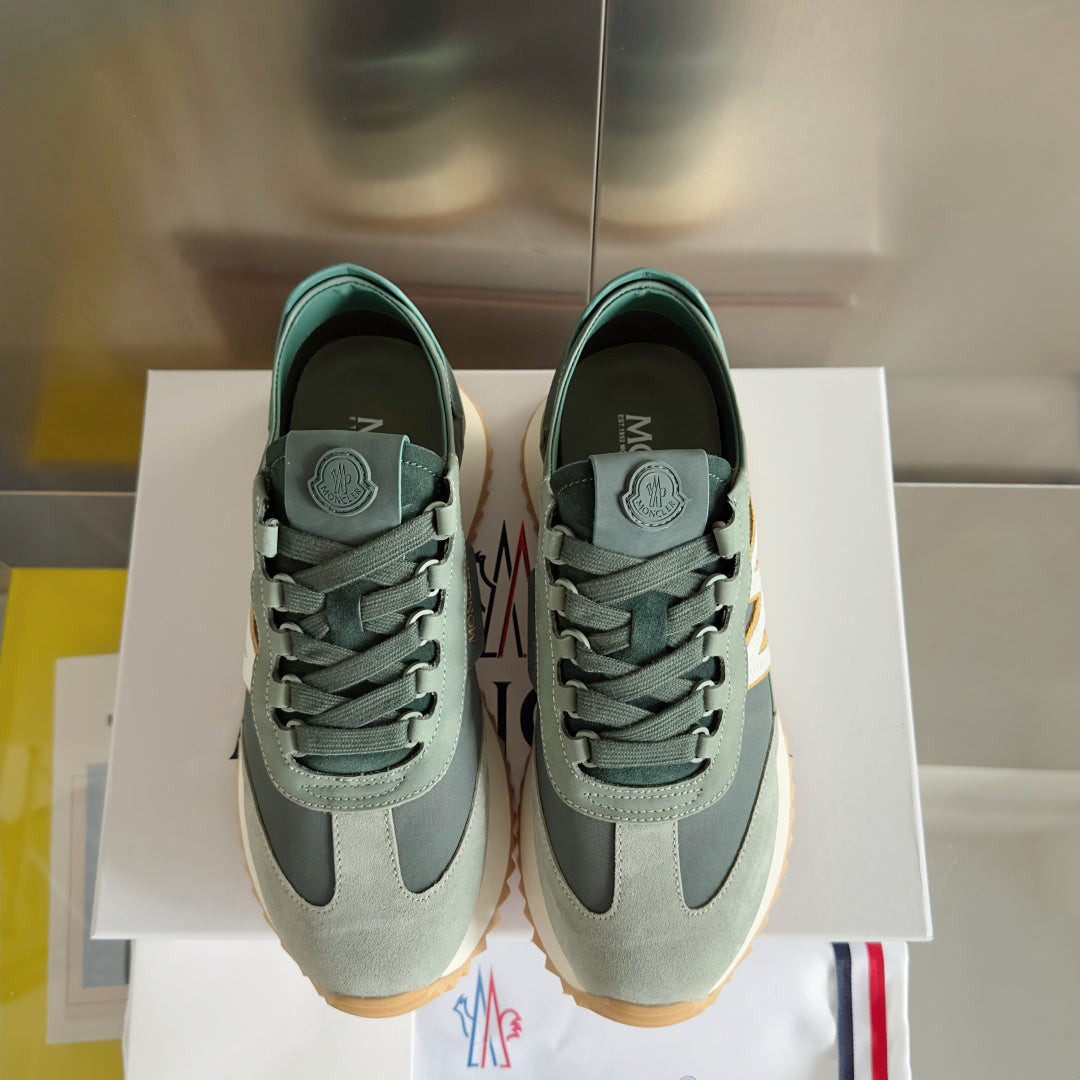 Moncler sneakers standing side-by-side in sage and dark green with lace-up design