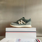 Moncler sneakers in sage and dark green on a box, with lace-up and textured sole tread