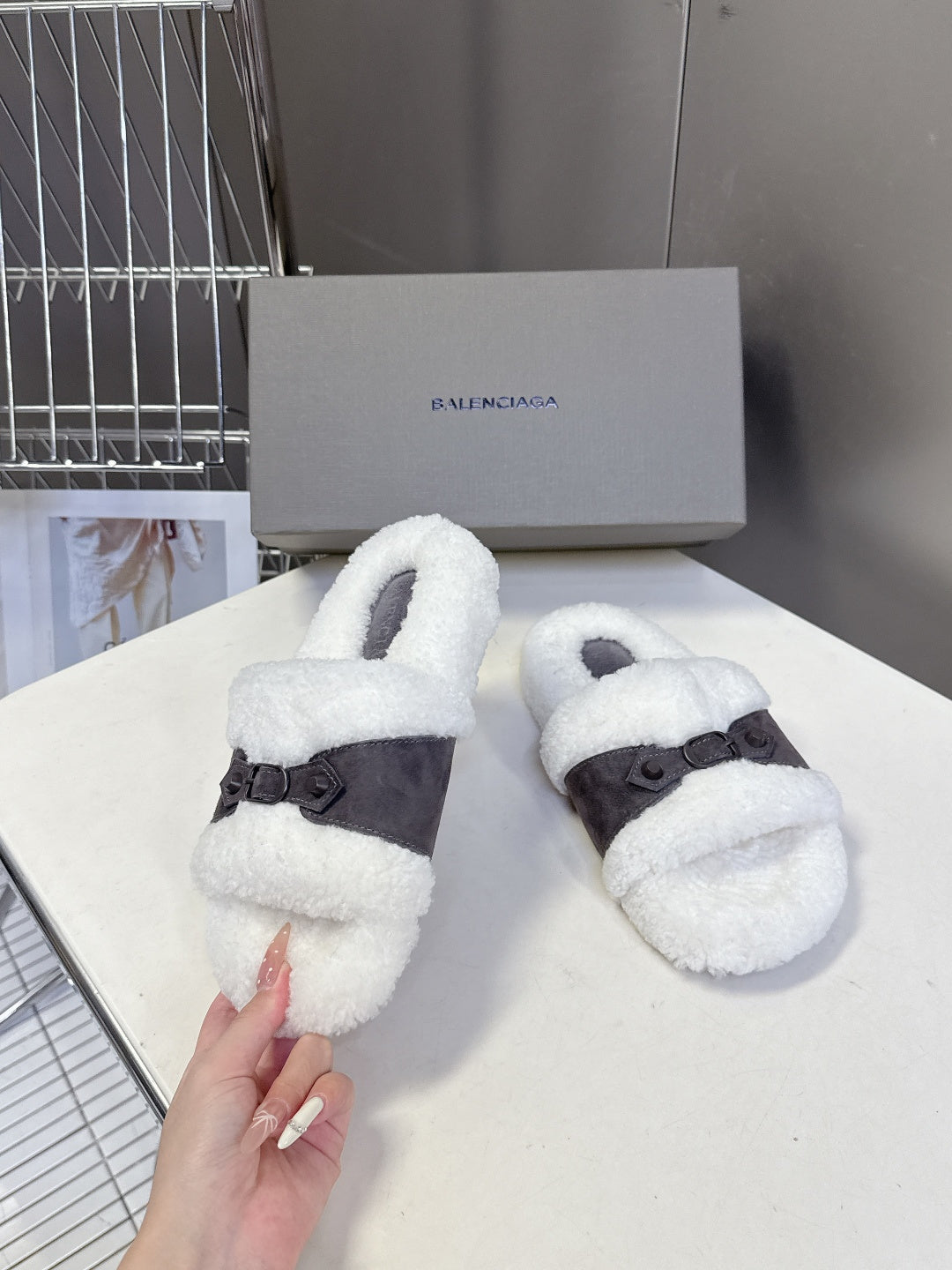 Faux shearling slide sandals with dark cross strap and buckles, white