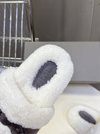 Faux shearling slide sandal close-up with molded dark footbed, white