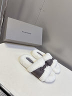 Faux shearling slide sandals with wide dark strap across instep, white