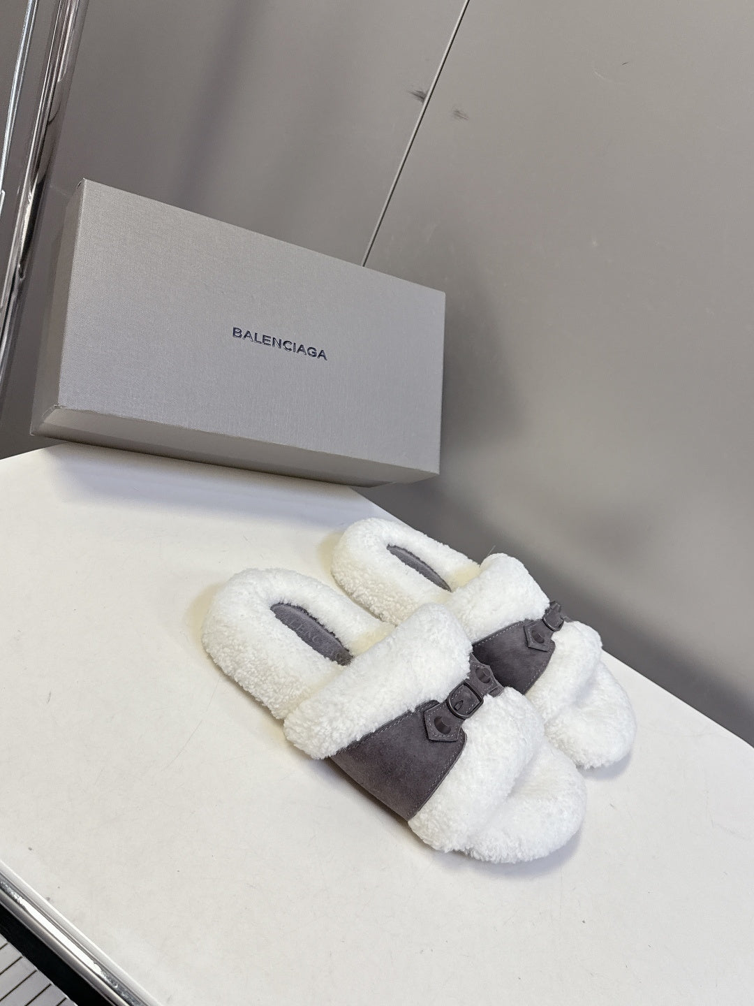 Faux shearling slide sandals with wide dark strap across instep, white