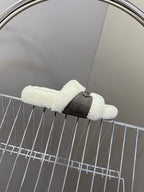 Faux shearling slide sandal with dark ankle strap, open toe, white