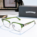 Green eyeglasses with clear lenses and metal rims, decorative bridge