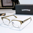 Gold and clear eyeglasses with green-tinted frame, decorative bridge