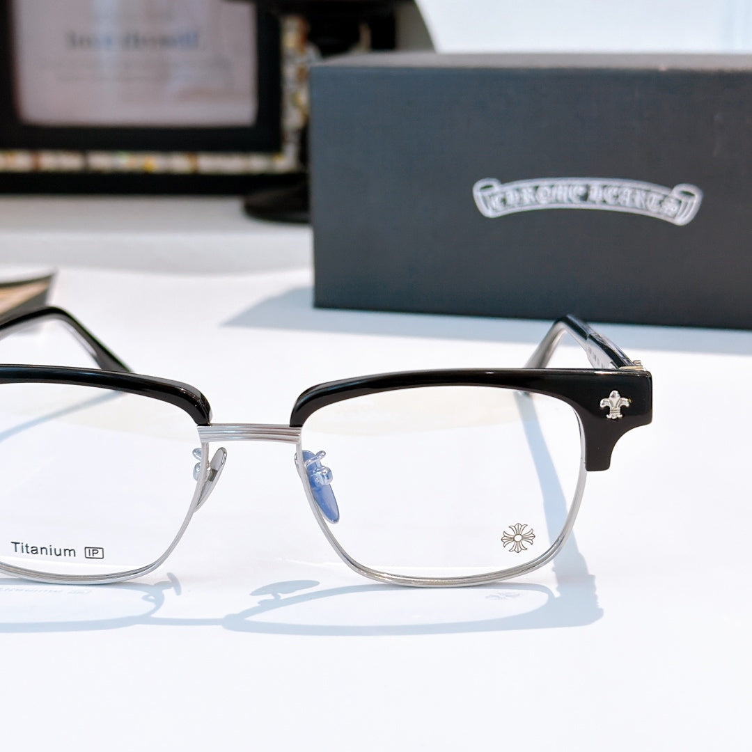 Black and silver eyeglasses with clear lenses, star detail on temple